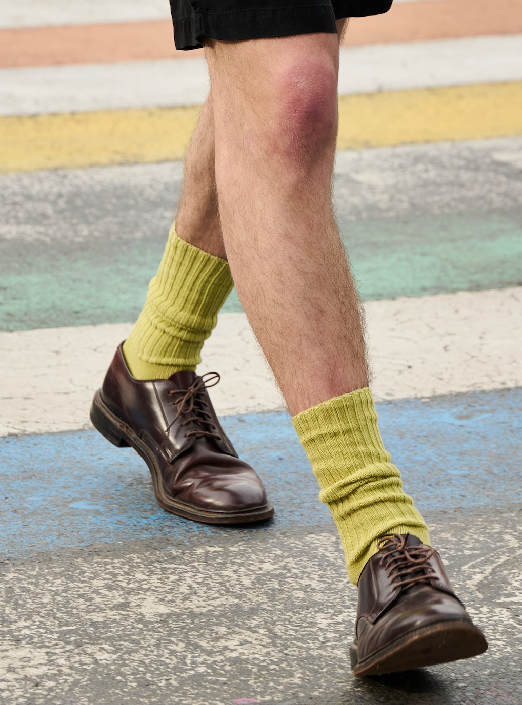 Man wearing black ribbed crew socks by Escuyer, made in Portugal
