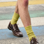 Man wearing khaki ribbed crew socks by Escuyer, made in Portugal