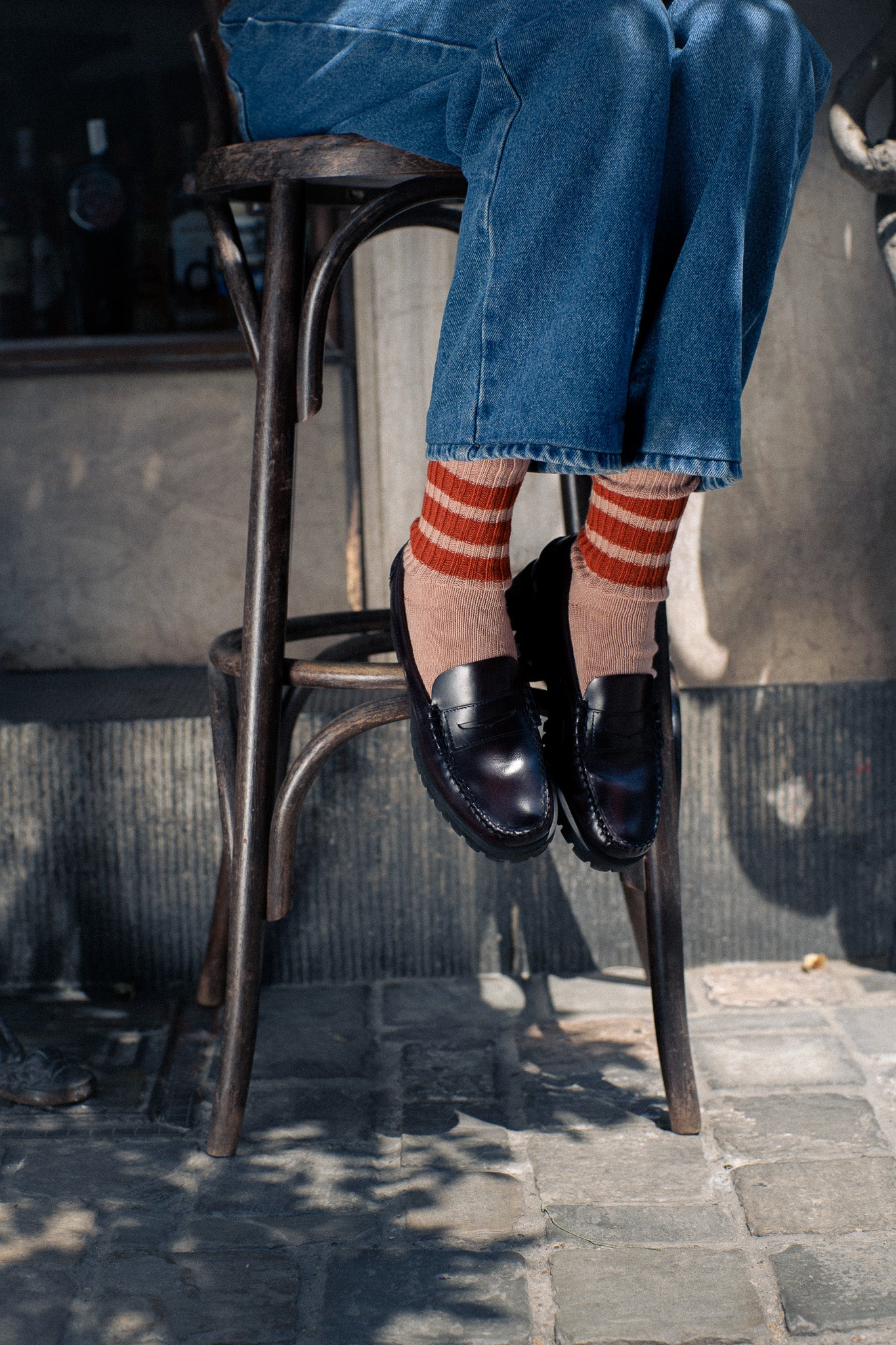 Woman wearing off black and green striped crew socks by Escuyer, made in Portugal