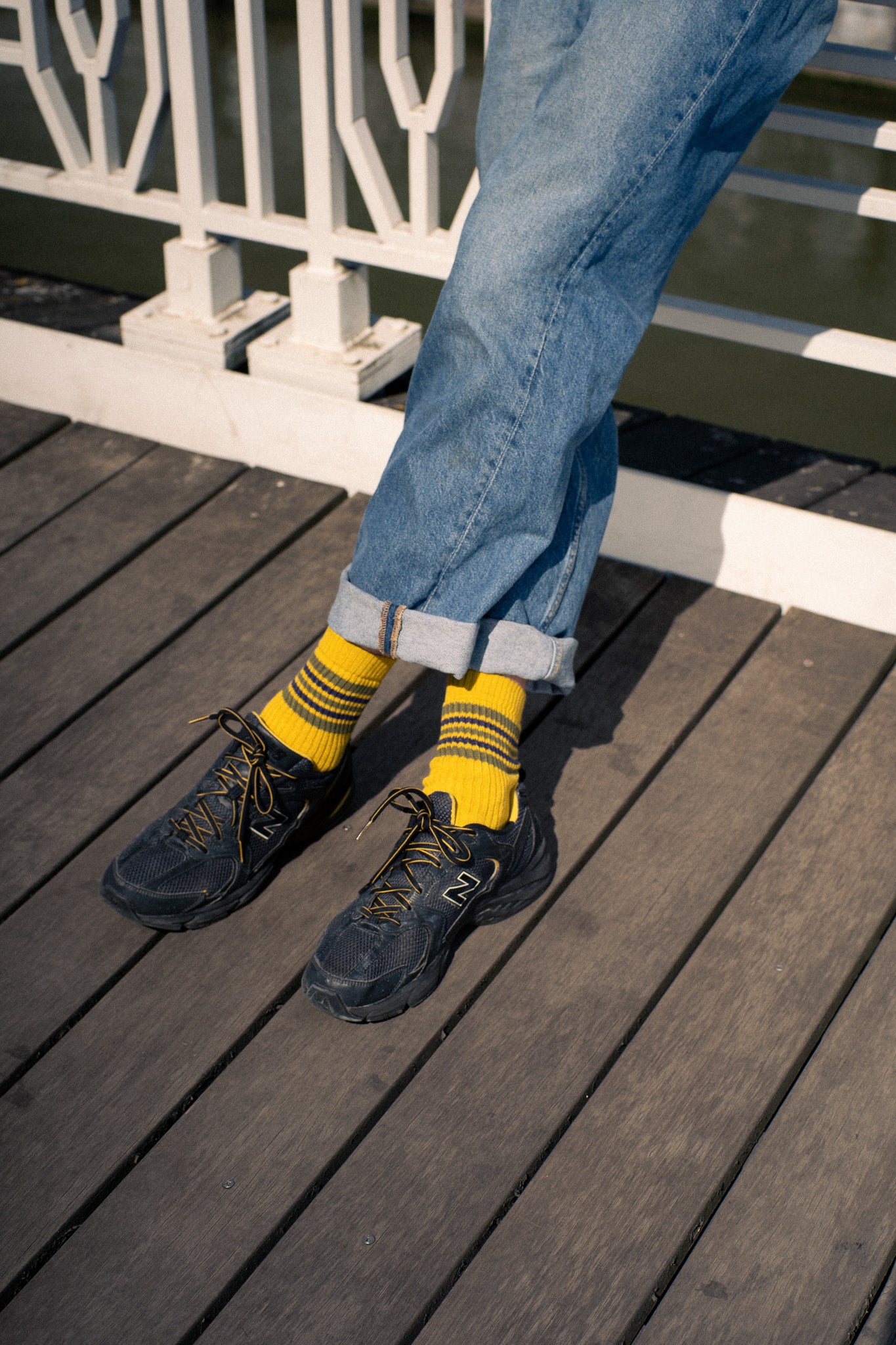 Escuyer Men's 5 Stripes Socks worn on a wooden deck — vintage athletics-inspired, knitted in Portugal