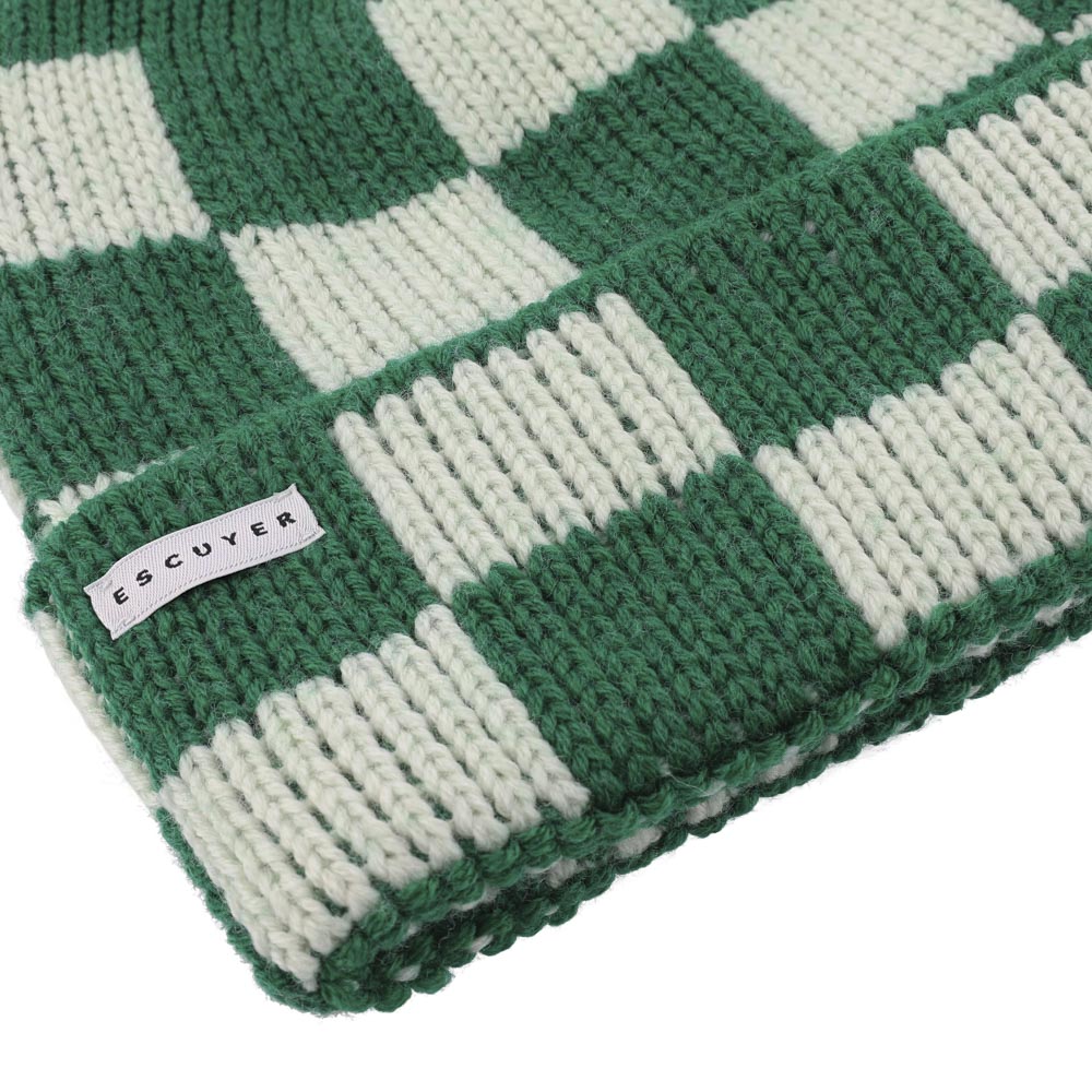 Green and white checkered knit beanie with 'Escuyer' label on a white background