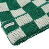 Green and white checkered knit beanie with 'Escuyer' label on a white background