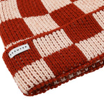 Side view of red and pink checkered knit merino beanie