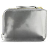 Escuyer Argent Métallisé zip wallet showing iridescent metallic finish and zip closure