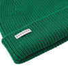 Green knit beanie with a visible brand label on a white background