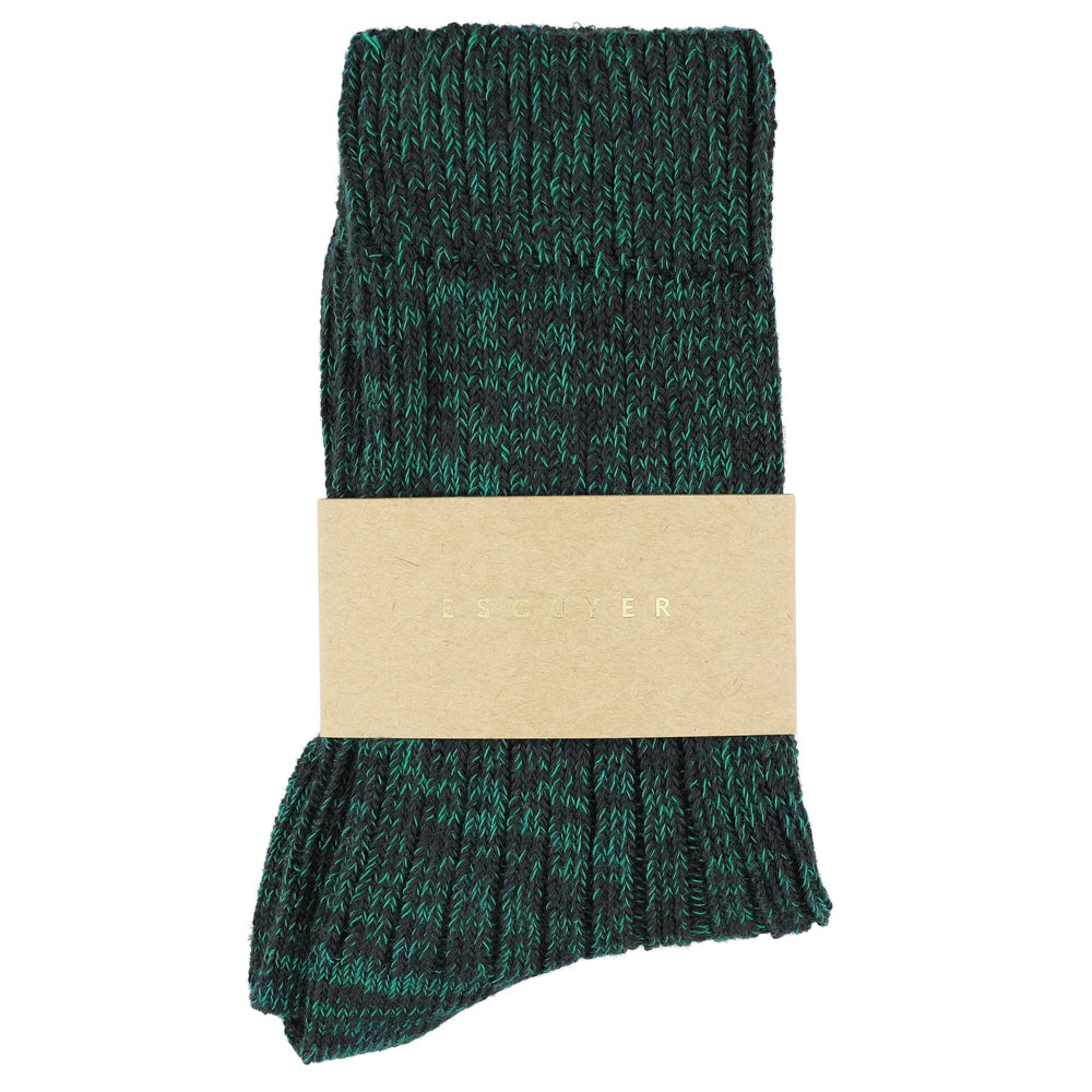 Green patterned socks with a beige label on a white background