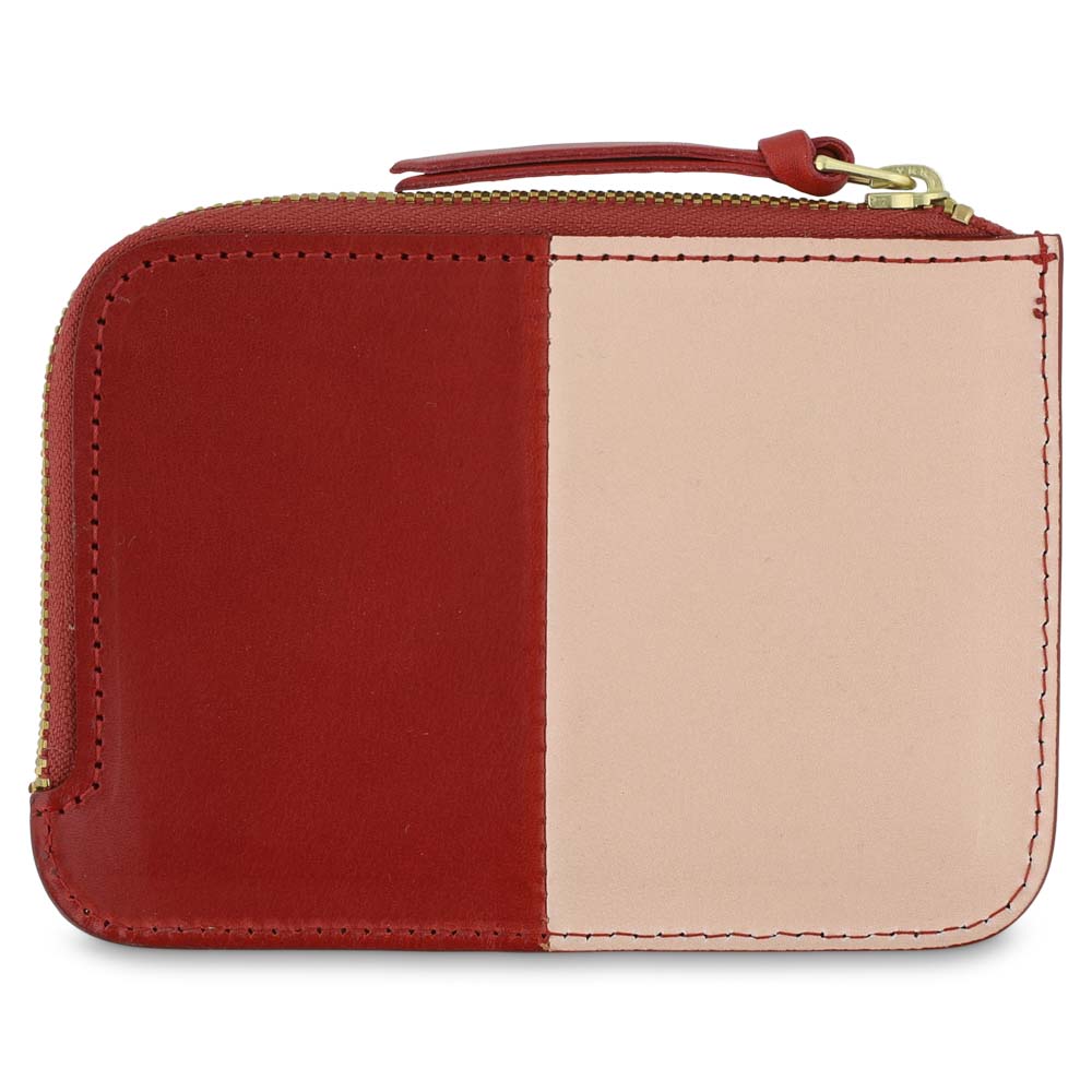Escuyer pink and red zip wallet showing vertical colour-block split and zip closure
