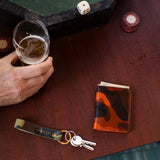 Escuyer camouflage slim leather wallet lifestyle — hand-dyed Italian veg-tan, made in Portugal