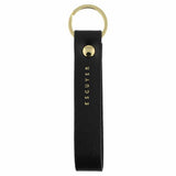 Escuyer black leather keychain — Italian vegetable tanned leather tab with gold metal ring and gold Escuyer logo