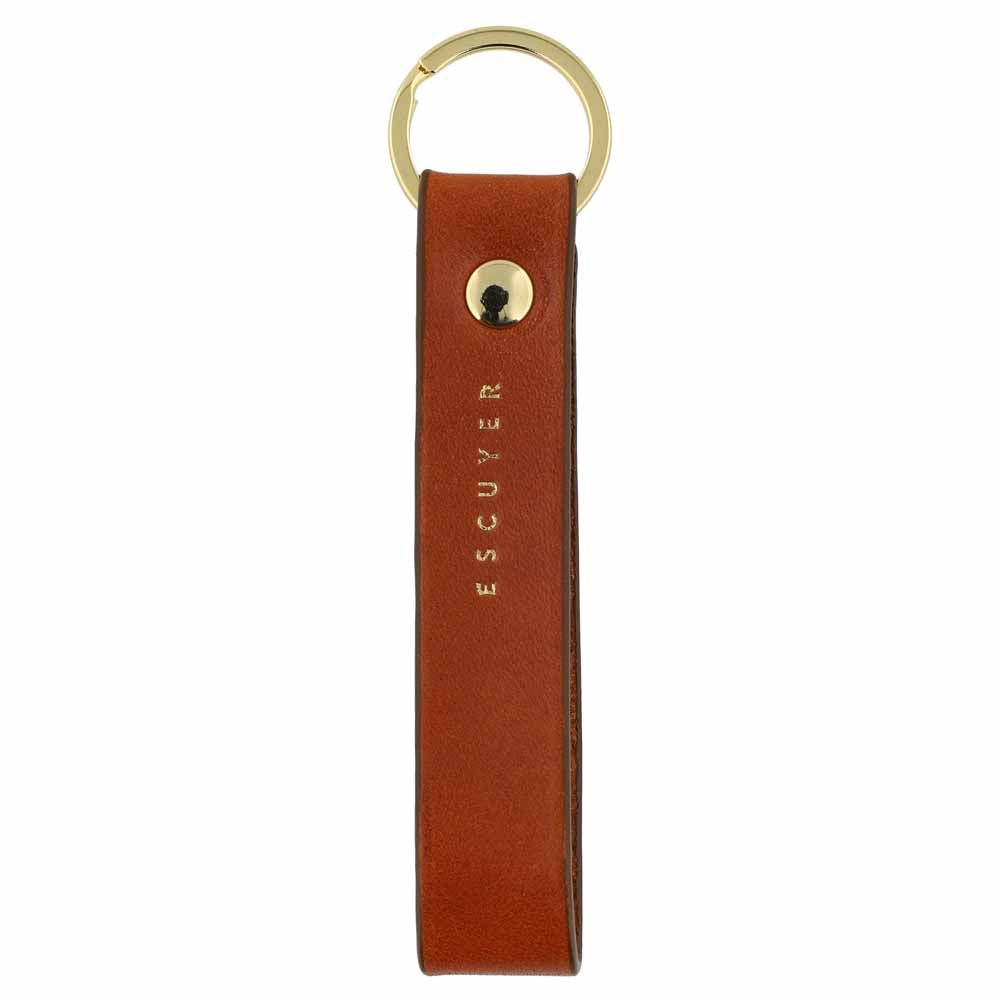 Escuyer cognac leather keychain — Italian vegetable tanned leather tab with gold metal ring and gold Escuyer logo