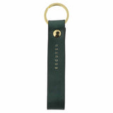 Escuyer green leather keychain — Italian vegetable tanned leather tab with gold metal ring and gold Escuyer logo