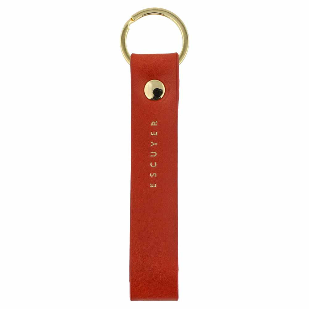 Escuyer orange leather keychain — Italian vegetable tanned leather tab with gold metal ring and gold Escuyer logo