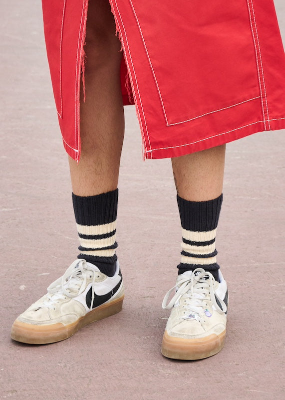 Woman wearing black and ecru striped crew socks by Escuyer, made in Portugal