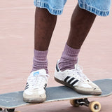 Man wearing off purple ribbed crew socks by Escuyer, made in Portugal