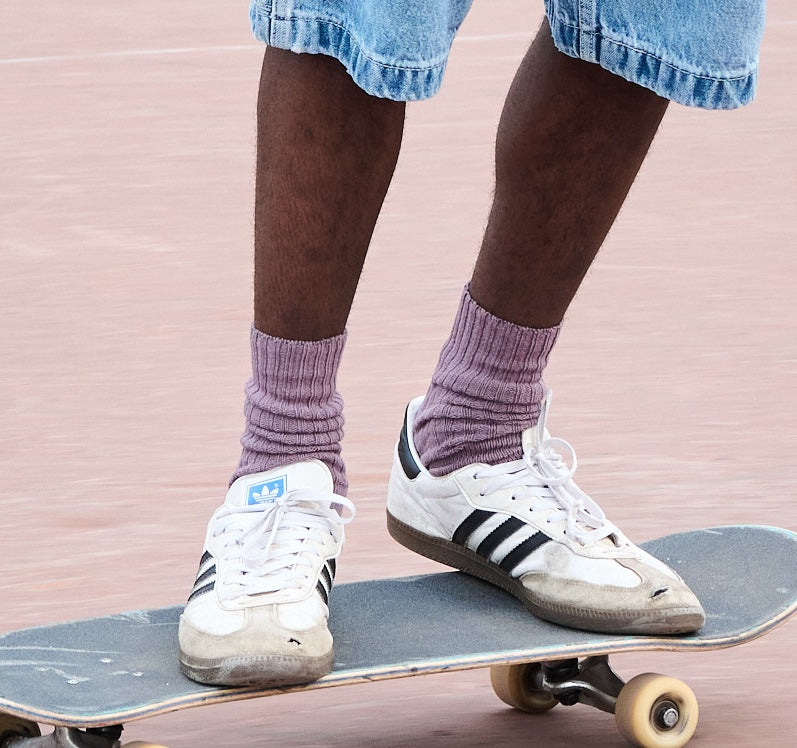 Man wearing off purple ribbed crew socks by Escuyer, made in Portugal