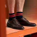 Man wearing Escuyer Men Striped Ankle Socks Orange / Ecru with brown loafers — vibrant summer style