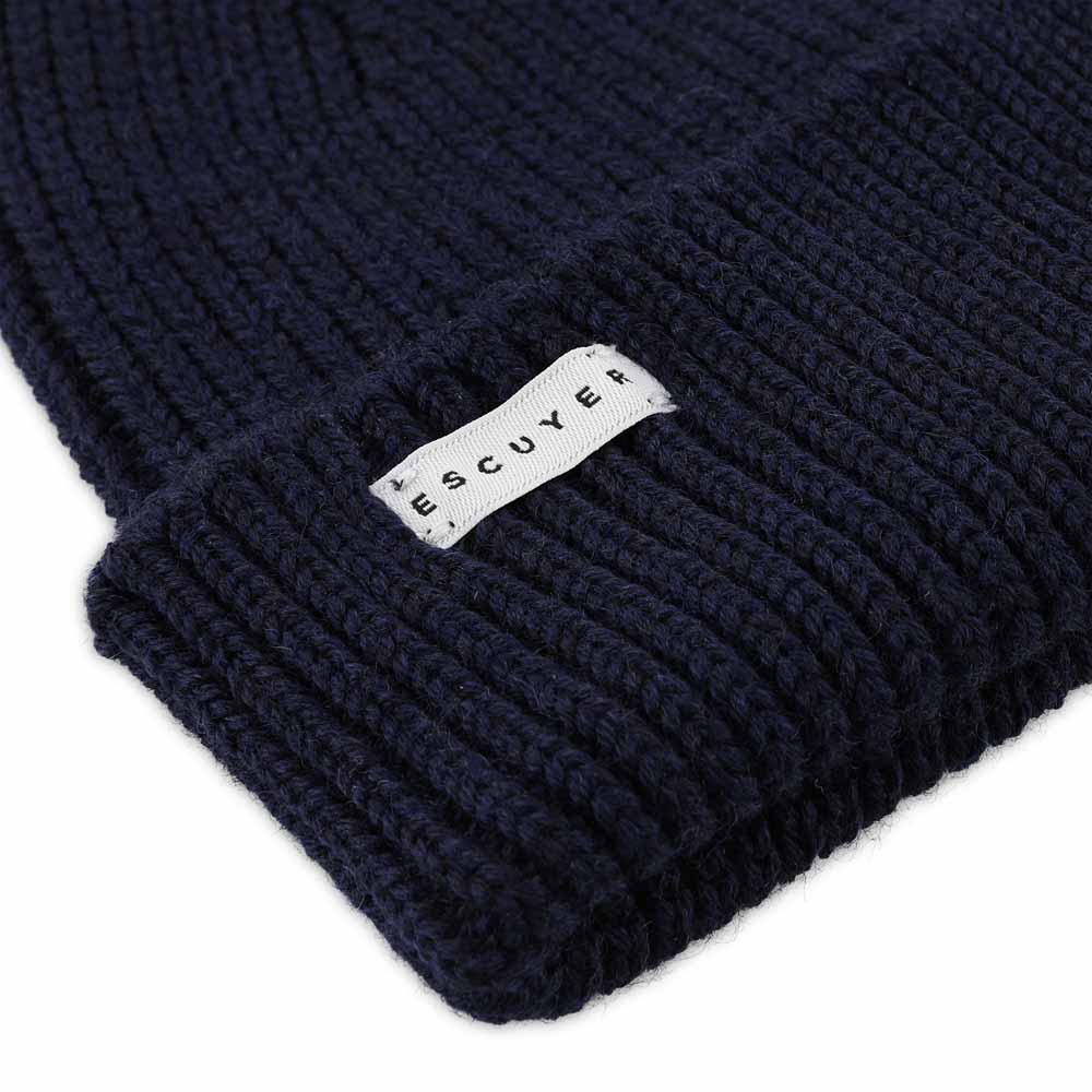 Side view of navy ribbed merino wool beanie with folded cuff